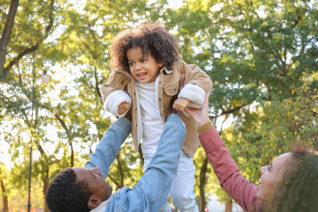 Happy family enjoying outdoor activities, representing financial security and peace of mind with KenInsure's life and health insurance services.